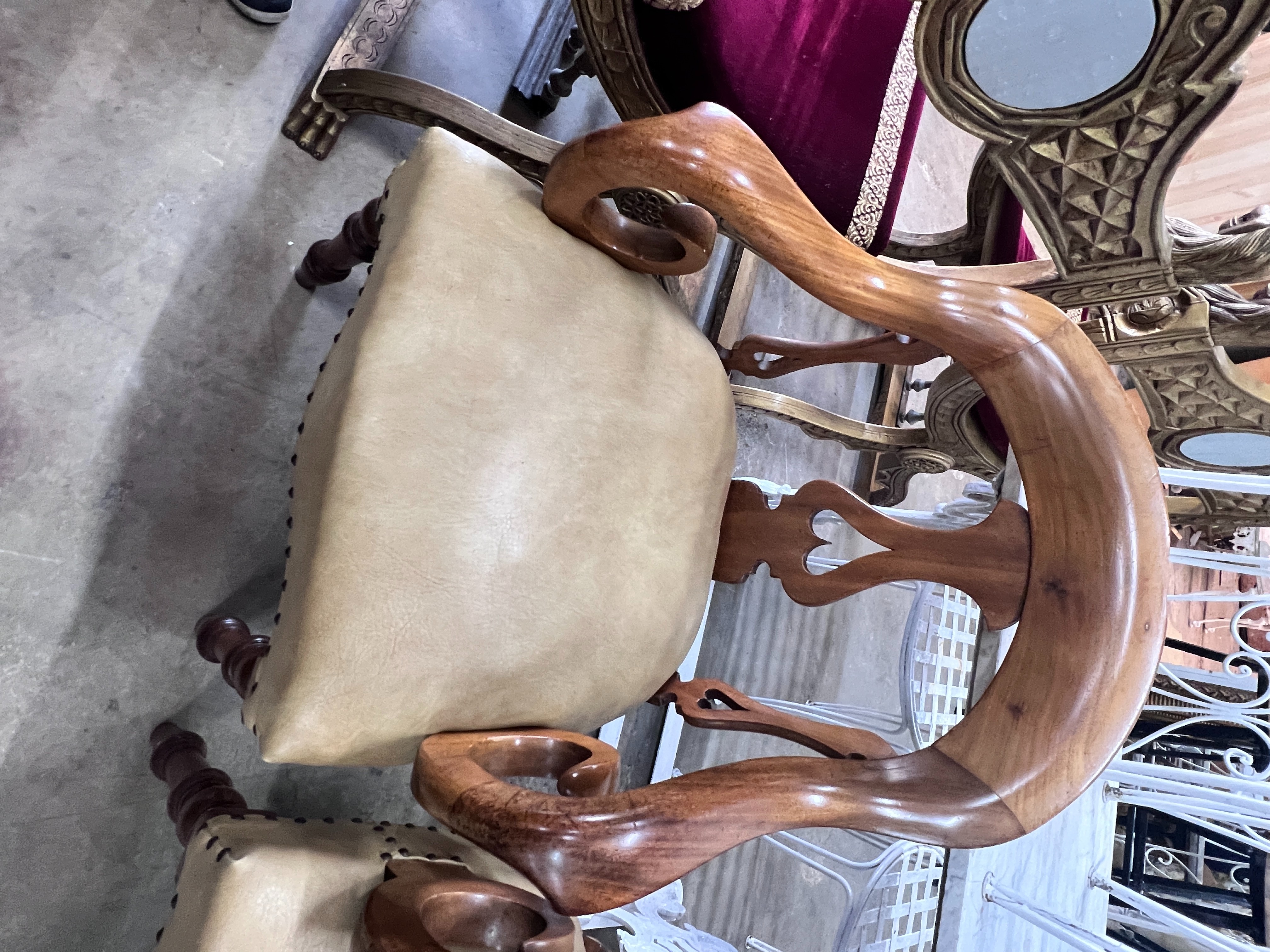 A pair of Victorian walnut elbow chairs with light brown leather seats, width 59cm, depth 51cm, height 90cm